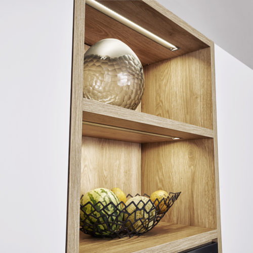alt="Close up of shelves with SYNTHIA wood laminate veneer and inset lighting"