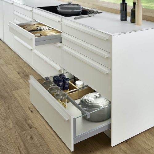 alt="Focus on BONDI super matte-lacquered kitchen island drawers with powdered griprail handles"