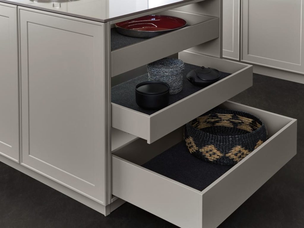 alt=" Close up of open shelving with pull out drawer and matte fabric insert and integrated lighting"