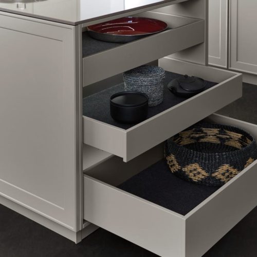 alt=" Close up of open shelving with pull out drawer and matte fabric insert and integrated lighting"