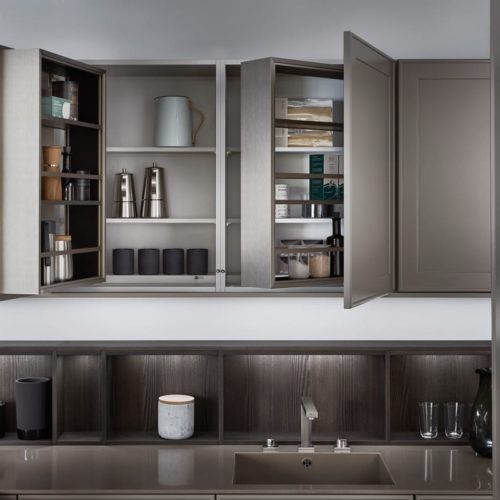 alt="Close up of upper cabinets with matte-lacquer front and moveable shelf inserts"