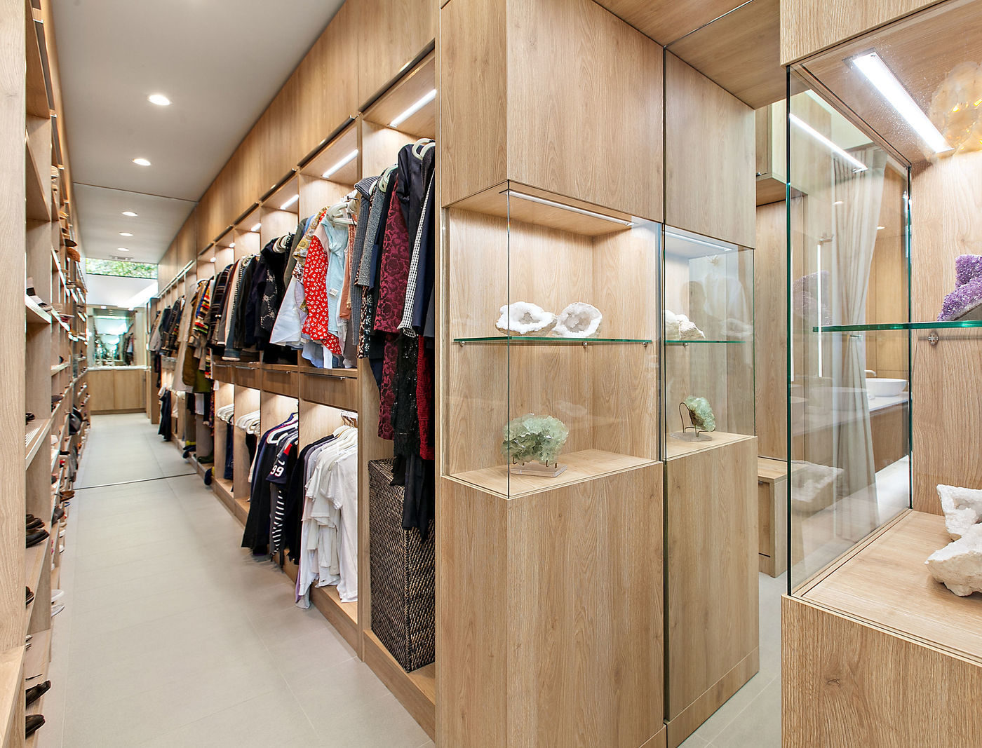 alt="Master walk-in closet with textured oak laminate paneling"