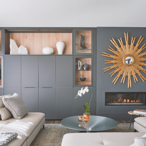 alt="Carbon gray satin matte-lacquer with built in fireplace and glass shelves"