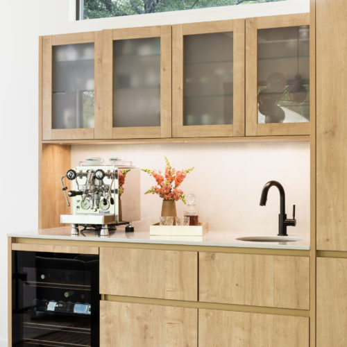 alt="bar nook with textured, handle-less karst oak cabinets"