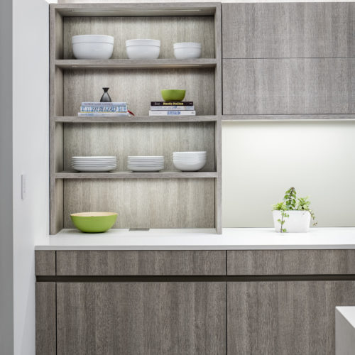 alt="Front view of open shelving unit with textured stone oak paneling and integrated LED strip lighting"