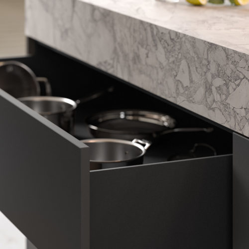 alt="close up of island drawers in fossil gray, also showing the detail of the ROCCA counter top"
