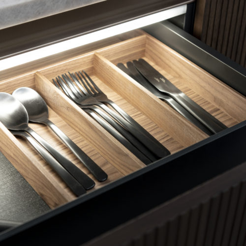 alt="close up of q-box interior drawer system with integrated cabinet lighting"
