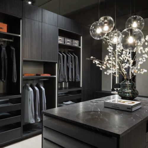 alt="Walk in closet with carbon gray matte satin lacquer cabinets"